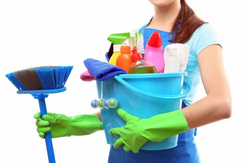 Cleaner preparing carpet cleaning equipment safely at a job site