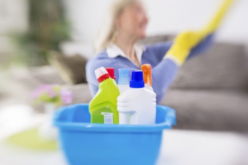 Cleaner placing warning signs near a freshly cleaned carpet area
