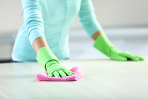 Close-up of a specialist inspecting different rug materials for cleaning in Harrow